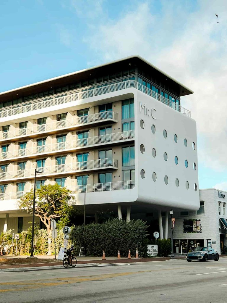 Modern hotel building in Coconut Grove under palm trees, Miami neighborhood guides
