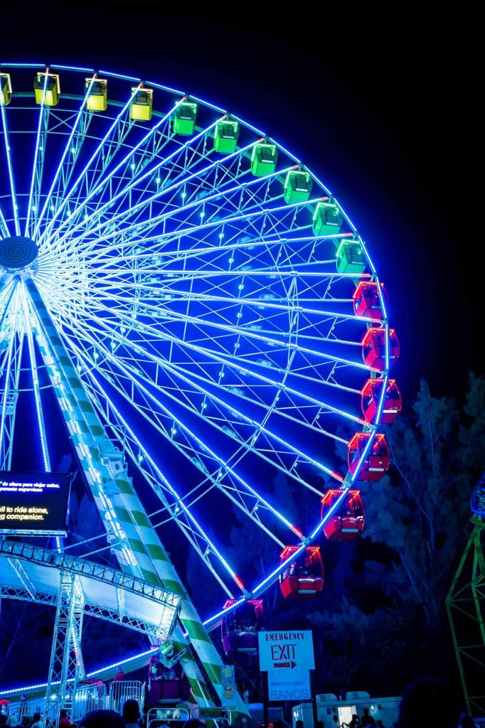 Illuminated Ferris wheel at a nighttime event in Miami.